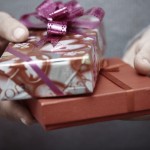 Human hands holding gift boxes